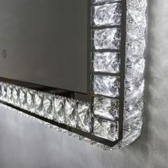 a mirror that is on the side of a wall with lights and some plastic wrap around it