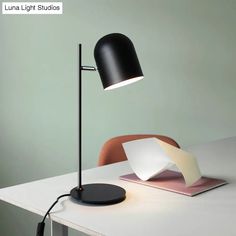 a desk lamp sitting on top of a white table