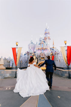 a bride and groom are walking in front of the castle at disney world during their wedding day