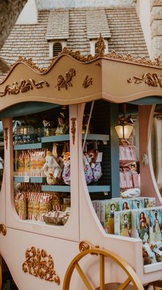 a pink and gold cart with pictures on it