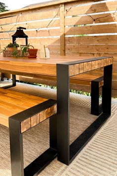 a wooden table with two benches next to it on top of a carpeted floor