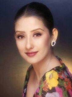 a woman in a floral dress posing for a photo with her hair up and eyes closed