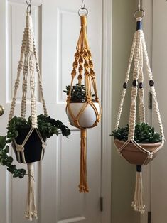 three macrame plant hangers with plants in them hanging on the door way