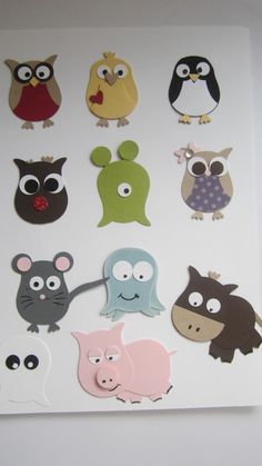 an assortment of animal stickers on a white surface, including owls and other animals