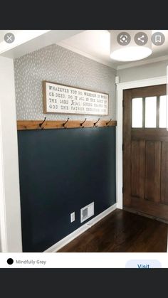 an empty room with a wooden door and sign on the wall