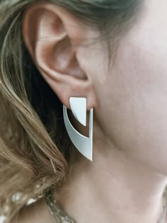 This pair of earrings is fully handmade on sterling silver . This minimalist design with simple lines and geometric shape fits almost with everything all day and night. I use 925 Sterling Silver, which requires polishing from time to time from oxidation. You can easily restore silver back to shine with a polishing cloth or use a polishing lotion for that extra shine. All of my jewelry is handmade please allow for small variances from piece to piece ,as this is a feature of owning one of the kind Modern Geometric Sterling Silver Earrings, Modern Sterling Silver Ear Climbers, Gothic Boutique, Modern Geometric Jewelry, Architectural Earrings, Earrings 2024, Artsy Accessories, Modern Silver Earrings, Wings Earrings