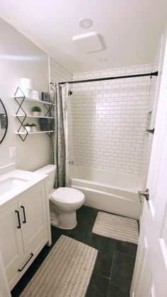 a bathroom with black and white tile flooring