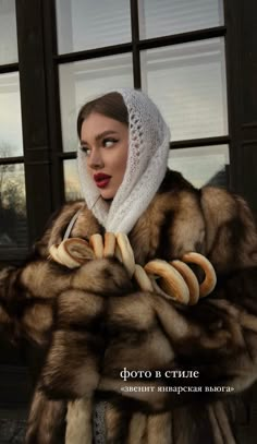 a woman wearing a fur coat and scarf