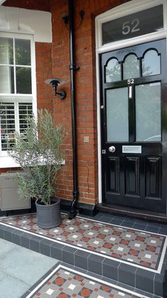 the front door of a house with a potted plant