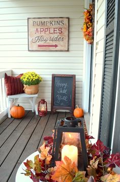 a porch decorated with fall leaves and candles