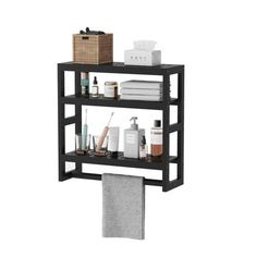 a shelf with towels and other bathroom items on top of it in front of a white background