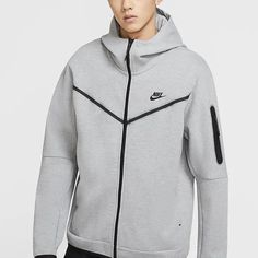 Are you looking for a comfortable and versatile Nike Tech Fleece gray hoodie? Look no further! KICKS CREW has exactly what you need - the best Nike Tech Fleece Men's Gray Hoodie. The unique mix of materials creates an incredibly soft texture that delivers lightweight warmth in any look. It is engineered with mesh panels to regulate your body temperature while its ribbed cuffs, stands collar and scuba-style hood provide extra coverage on colder days. Whether worn casually or open up as a layering Nike Tech Fleece Men, Nike Tech Fleece Hoodie, Classic Wardrobe Essentials, Tech Fleece Hoodie, Nike Sportswear Tech Fleece, Grey Hoodie Men, Men's Sportswear, Nike Tech Fleece, Nike Tech