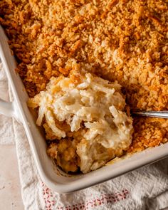 a casserole dish with mashed potatoes and crumbs on the side