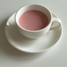 a cup of tea sitting on top of a white saucer