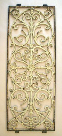 an old iron screen hanging on the wall