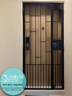 the front door to an apartment with black iron bars and wood panels on it's sides