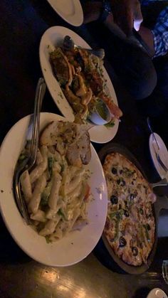 several plates of food on a table with silverware