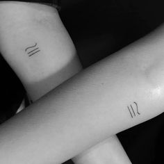 two people with matching tattoos on their arms