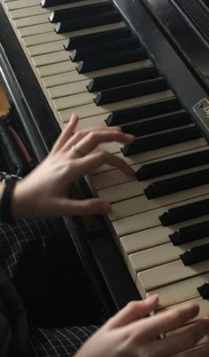 two hands are playing the piano together