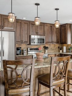 a kitchen with wooden cabinets and an island