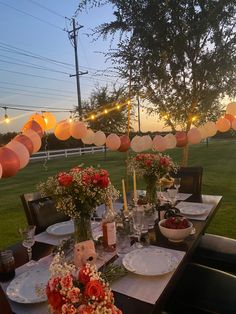 a long table with plates and flowers on it