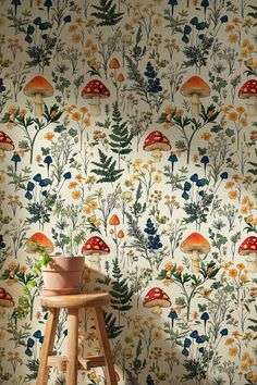 a mushroom wallpaper with flowers and plants on the wall next to a wooden stool