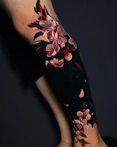 a woman's leg with flowers painted on it