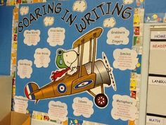 a bulletin board with writing on it that says soaring in writing and an image of a cartoon airplane