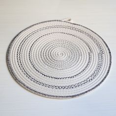 a white and black place mat on top of a table