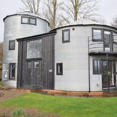 a round house with two large metal silos on the front and side of it