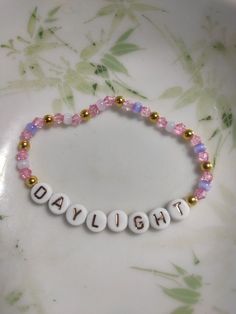 a beaded bracelet with the word daylight written on it