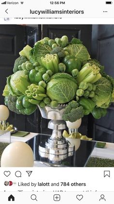 a vase filled with lots of green vegetables