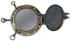 an antique brass porthole mirror with metal handles