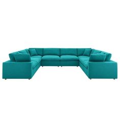 a blue sectional couch with pillows on it's back and the seat facing outward