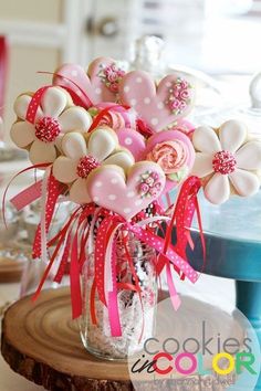 a vase filled with lots of cookies on top of a table