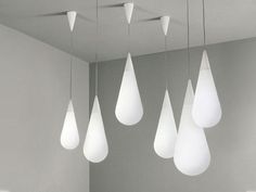 five white lights hanging from the ceiling in a room