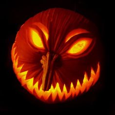 a carved pumpkin with an evil face on it