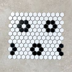 a white and black mosaic tile with hexagons on it's sides