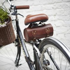 a bicycle with a leather saddle on the front