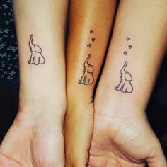 two people with matching tattoos on their arms and feet, one has an elephant and the other has a dog