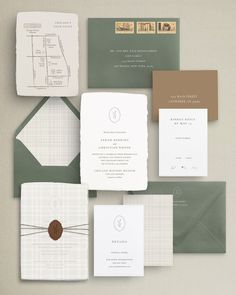 an assortment of wedding stationery and envelopes