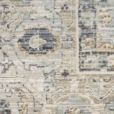 an area rug with various colors and patterns on it, including greys, oranges, yellows and grays