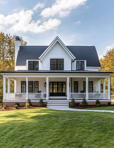 a white house with black shutters on the front porch