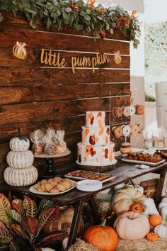 a table topped with lots of different types of cakes and desserts on top of hay