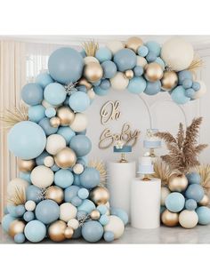 a blue and gold balloon arch for a baby shower