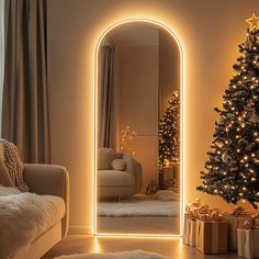 a living room with a christmas tree in the corner and a large mirror on the wall