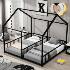 a child's bedroom with a black and white house bed