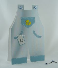 a blue and white striped card with a yellow rubber ducky on it's chest