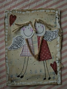 two little angels are holding hands on a piece of paper with hearts in the background