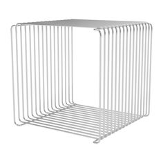 a white metal shelf sitting on top of a white floor